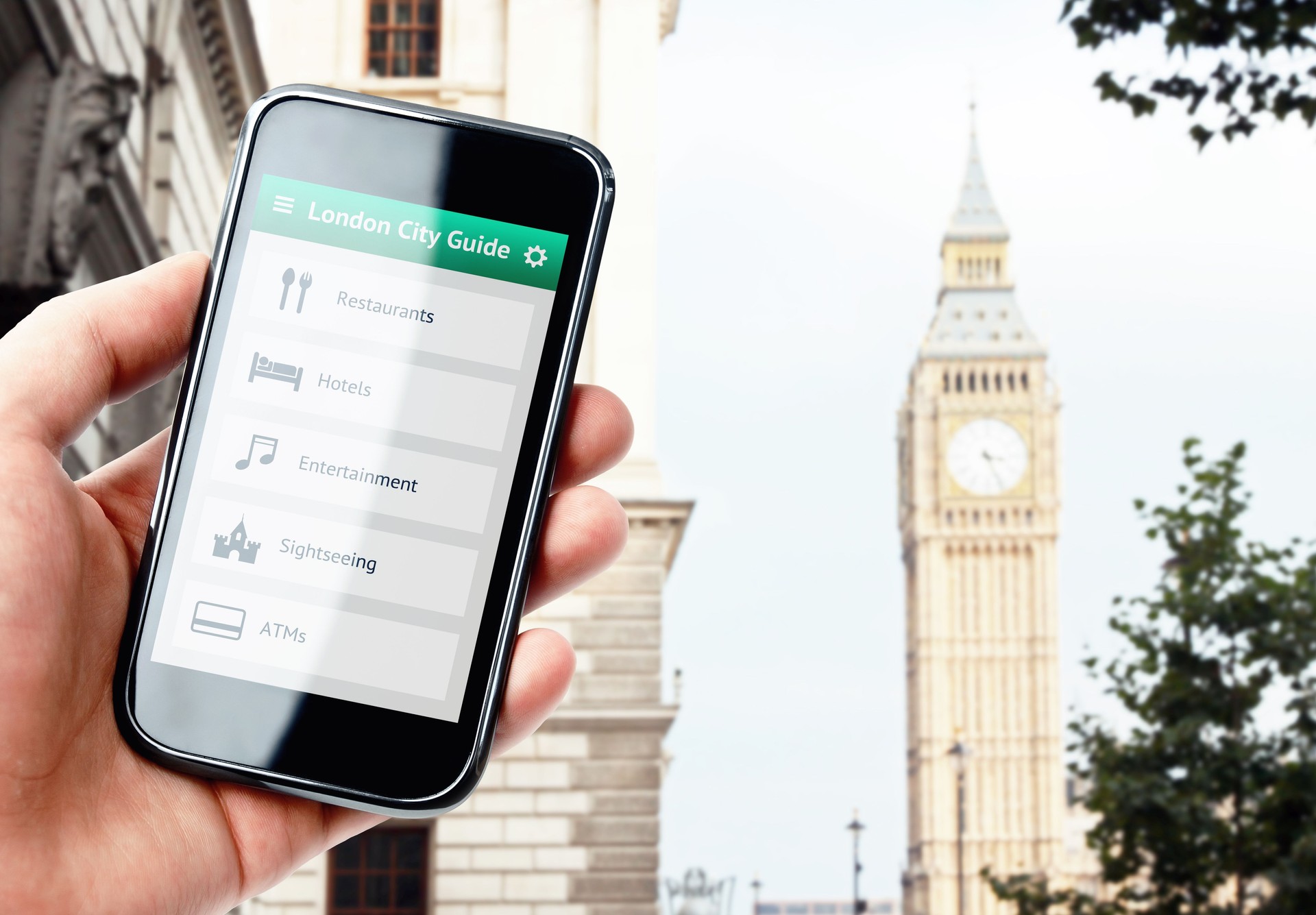 Hand holding smartphone with city guide in London